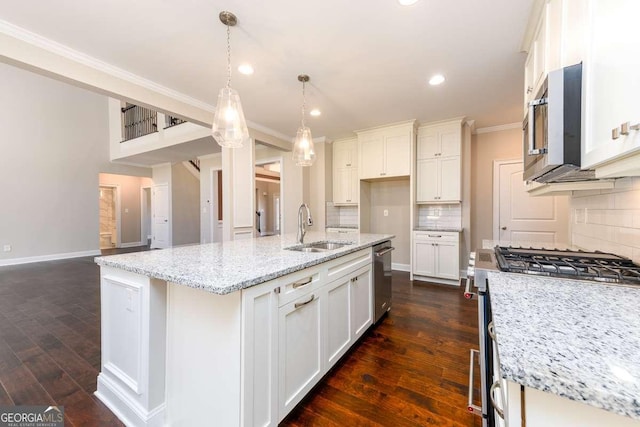 kitchen with appliances with stainless steel finishes, tasteful backsplash, dark wood finished floors, a sink, and ornamental molding