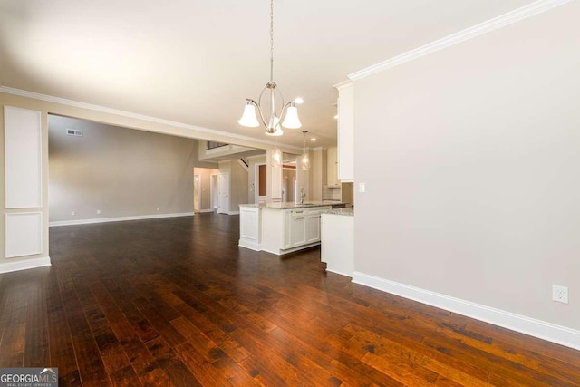 unfurnished living room featuring visible vents, baseboards, dark wood-style flooring, crown molding, and a chandelier