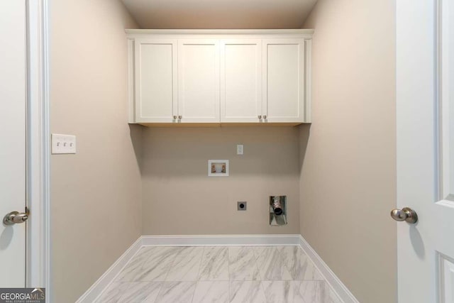 washroom featuring baseboards, washer hookup, cabinet space, electric dryer hookup, and marble finish floor