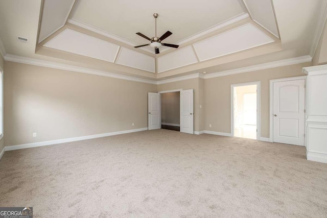 carpeted empty room with crown molding, baseboards, a ceiling fan, and visible vents