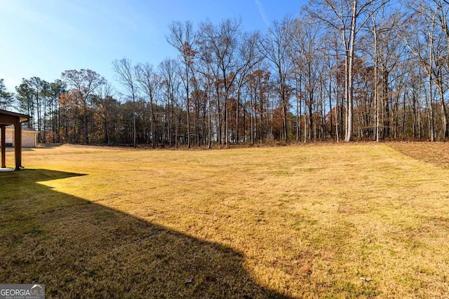 view of yard featuring a wooded view