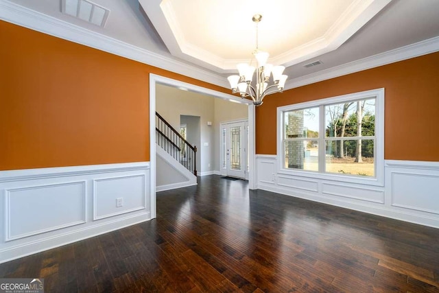 interior space with dark wood-style floors, visible vents, stairs, and a tray ceiling