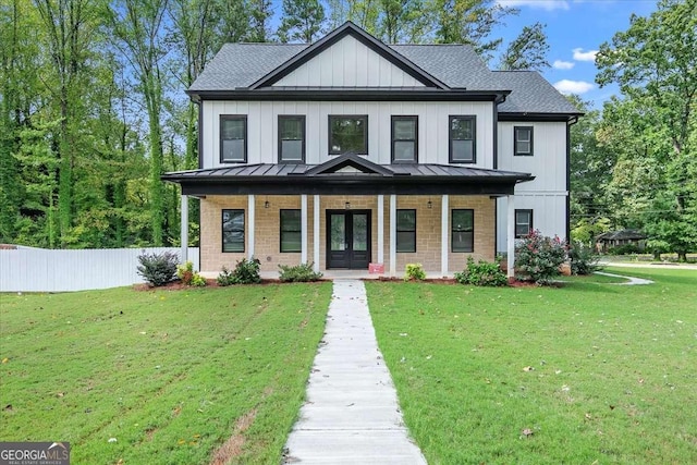 modern inspired farmhouse with covered porch, french doors, and a front lawn