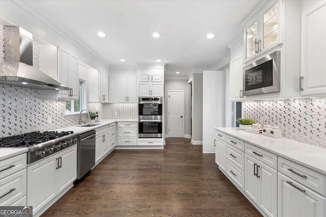 kitchen with stainless steel appliances, sink, wall chimney range hood, white cabinets, and dark hardwood / wood-style floors