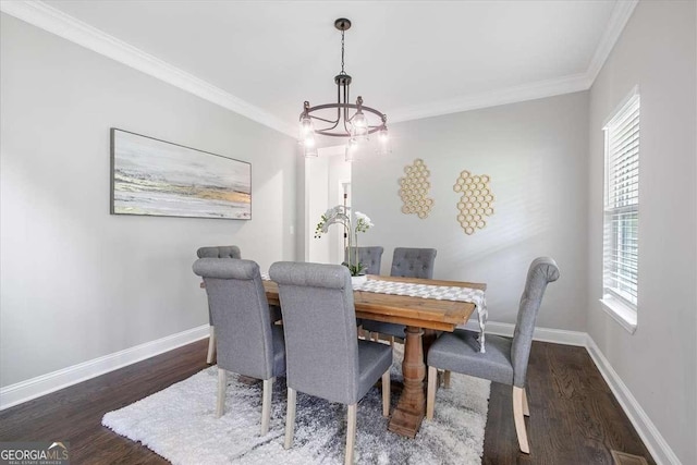 dining space with dark hardwood / wood-style flooring, crown molding, a wealth of natural light, and a chandelier