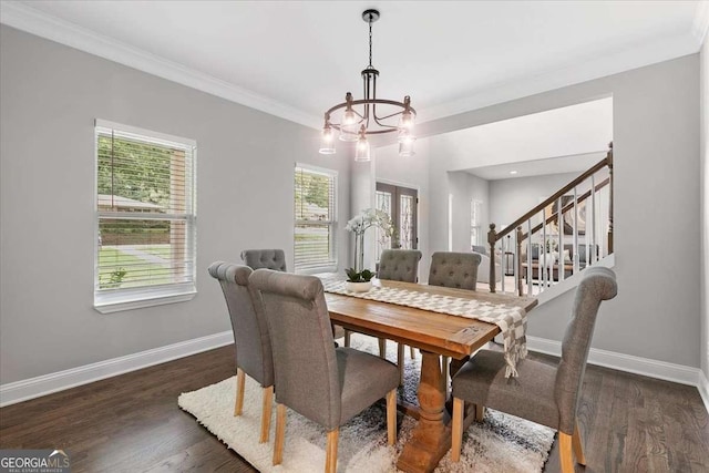 dining area with a chandelier, dark hardwood / wood-style floors, and ornamental molding