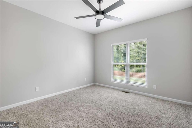 carpeted empty room featuring ceiling fan