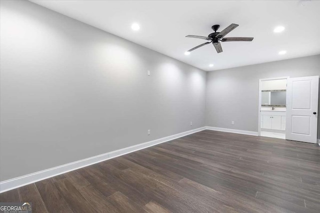 empty room featuring dark hardwood / wood-style floors and ceiling fan