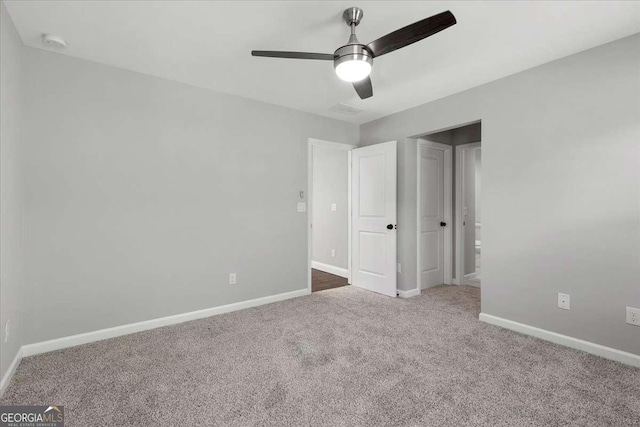 unfurnished bedroom featuring carpet and ceiling fan