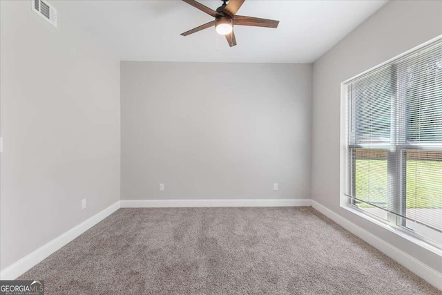 carpeted spare room featuring ceiling fan