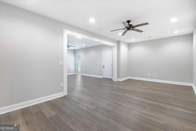 spare room with ceiling fan and dark wood-type flooring