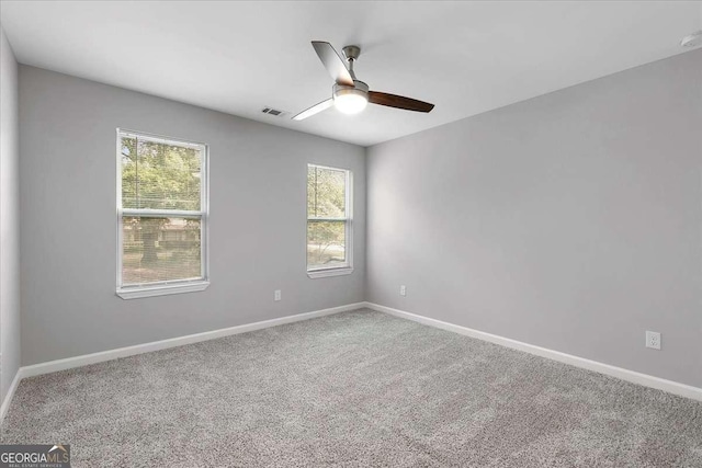 carpeted empty room featuring ceiling fan