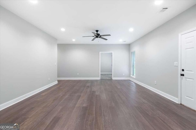 unfurnished room featuring ceiling fan and dark wood-type flooring