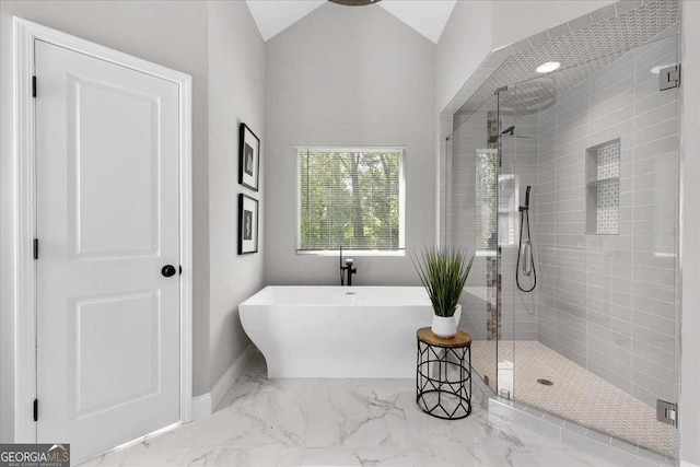 bathroom with lofted ceiling and independent shower and bath