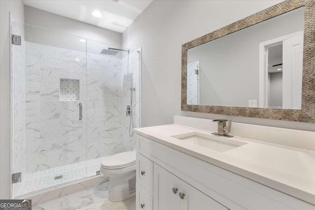 bathroom with vanity, an enclosed shower, and toilet