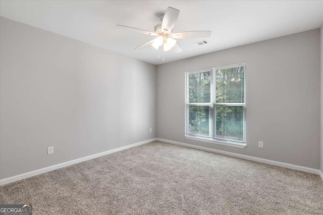 spare room with carpet flooring and ceiling fan