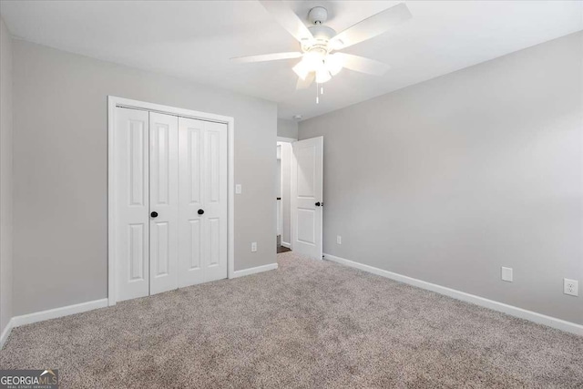 unfurnished bedroom featuring carpet flooring, ceiling fan, and a closet