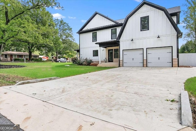 modern inspired farmhouse featuring a garage and a front lawn