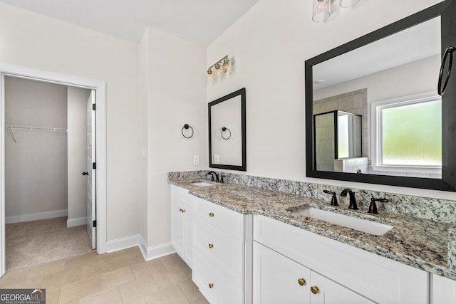 bathroom with vanity and a shower with door