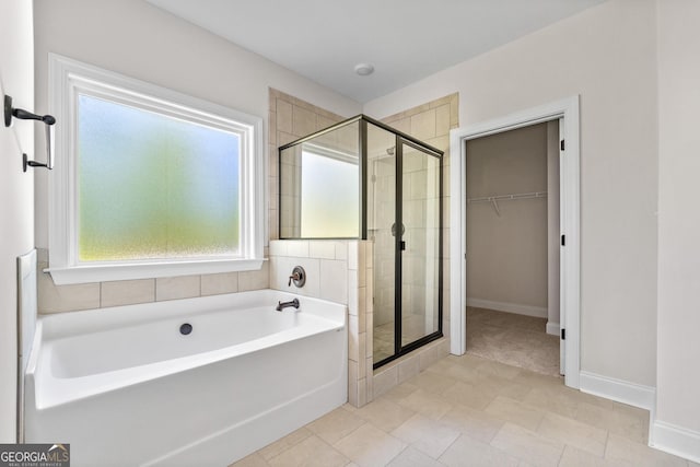 bathroom featuring shower with separate bathtub and tile patterned floors