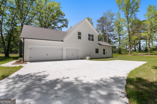 view of home's exterior with a yard and a garage