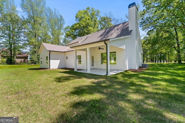 rear view of property with a lawn, ceiling fan, central air condition unit, and a patio