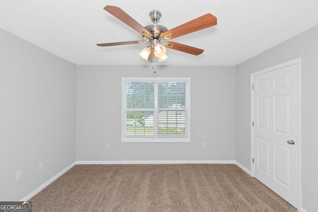 unfurnished room featuring ceiling fan and light colored carpet