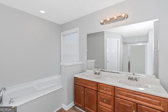 bathroom with vanity and independent shower and bath