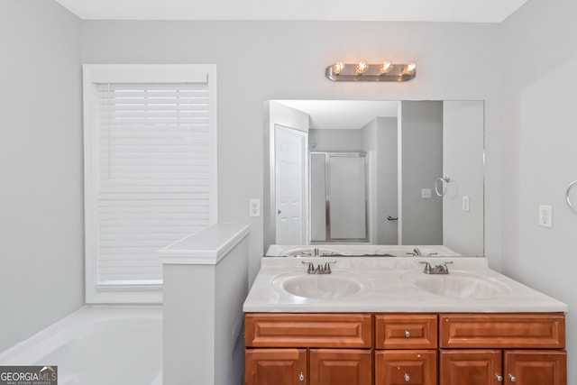 bathroom with vanity and shower with separate bathtub