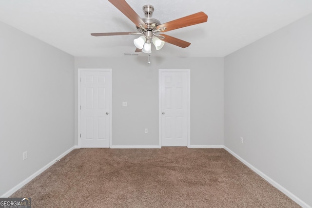 empty room with ceiling fan and carpet floors