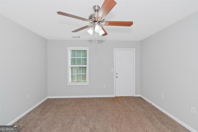 spare room featuring ceiling fan and carpet floors