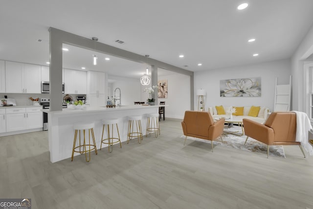 living room featuring light hardwood / wood-style flooring and sink