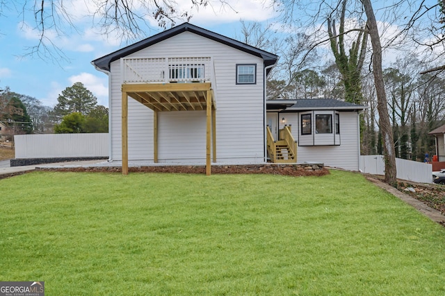 rear view of house featuring a yard