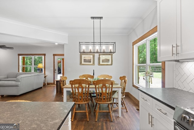 dining area with ceiling fan, dark hardwood / wood-style flooring, and crown molding