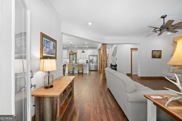 living room with crown molding, ceiling fan, and dark hardwood / wood-style floors