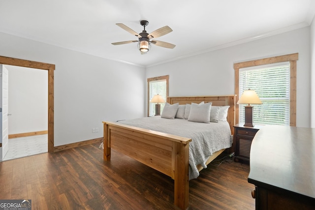 bedroom with ceiling fan, crown molding, and dark wood-type flooring