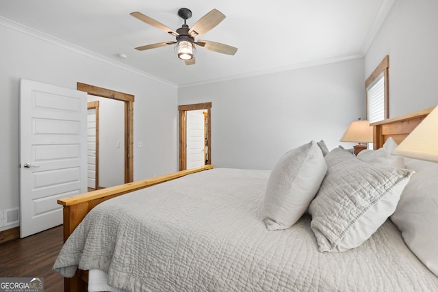 bedroom with ceiling fan, ornamental molding, and dark wood-type flooring