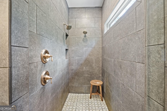 bathroom with tiled shower