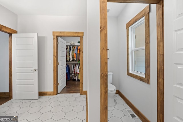 hall featuring light tile patterned flooring