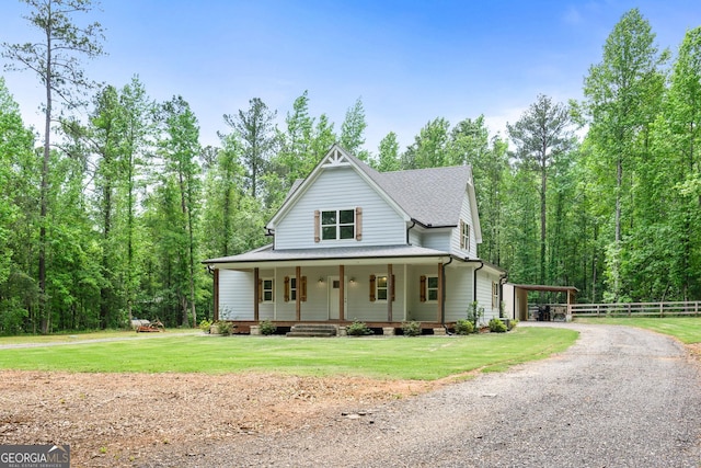 farmhouse inspired home with a front lawn, covered porch, and a carport