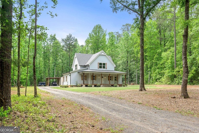 farmhouse-style home with a porch and a carport