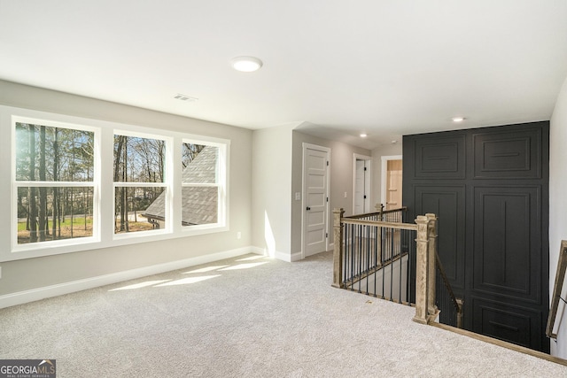 unfurnished room featuring light carpet, visible vents, baseboards, and recessed lighting