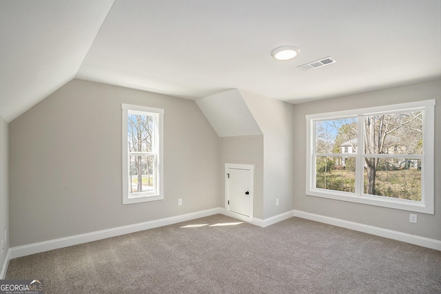 bonus room with vaulted ceiling, carpet floors, visible vents, and baseboards