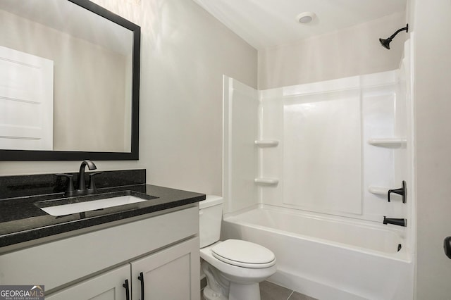 bathroom featuring toilet, vanity, shower / tub combination, and tile patterned floors