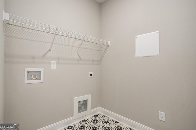 washroom with hookup for a washing machine, hookup for an electric dryer, laundry area, visible vents, and baseboards