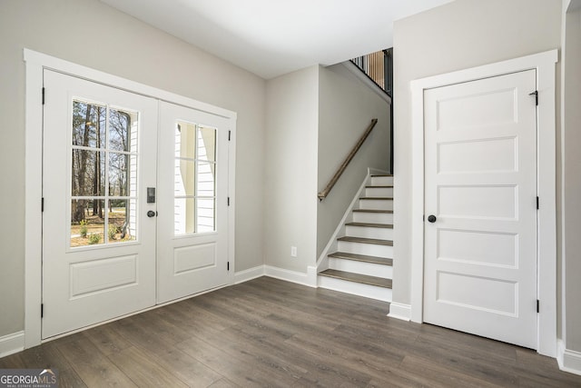 entryway featuring baseboards, stairway, dark wood-style flooring, and french doors