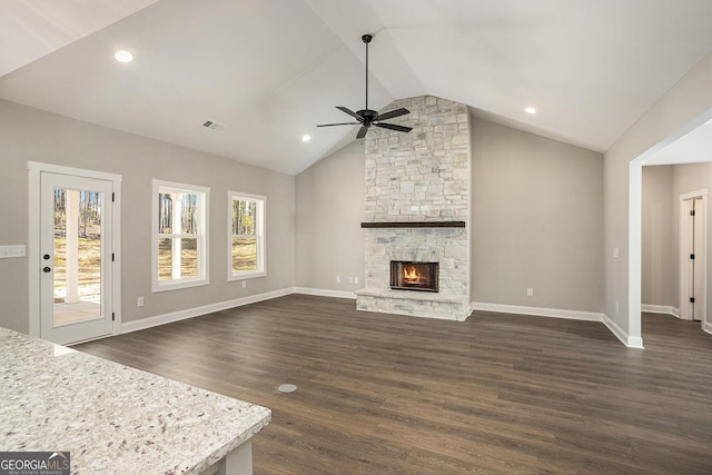 unfurnished living room with lofted ceiling, dark wood-style flooring, a fireplace, a ceiling fan, and baseboards