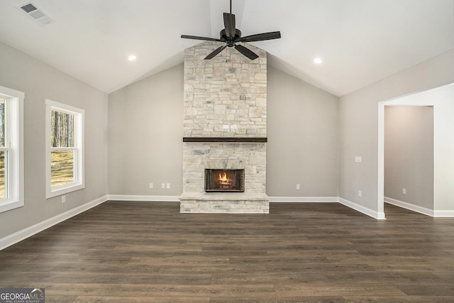 unfurnished living room with vaulted ceiling, dark wood-type flooring, a fireplace, and baseboards