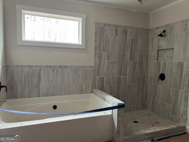 bathroom with shower with separate bathtub