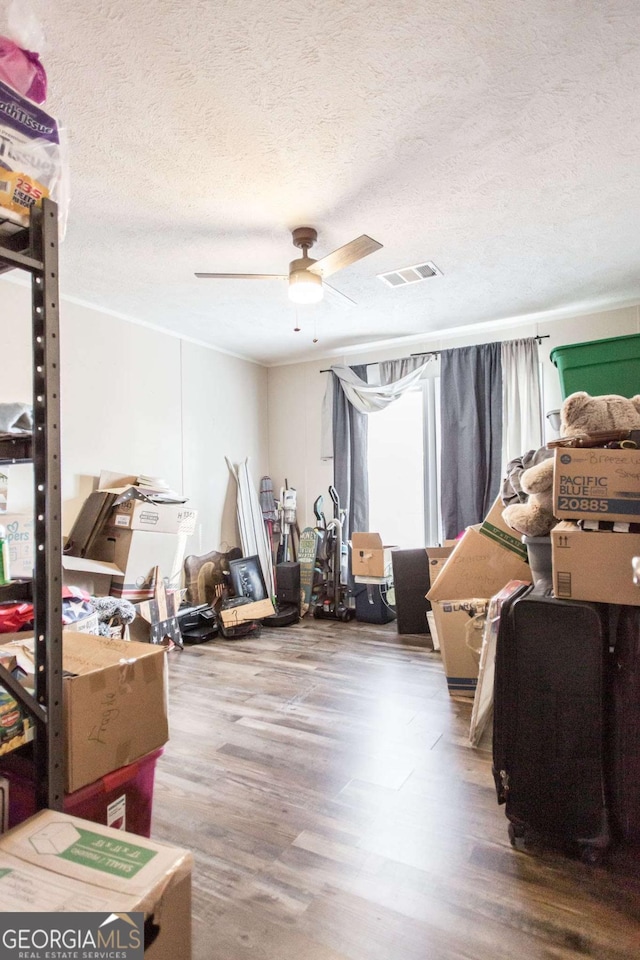 miscellaneous room featuring hardwood / wood-style floors, a textured ceiling, and ceiling fan